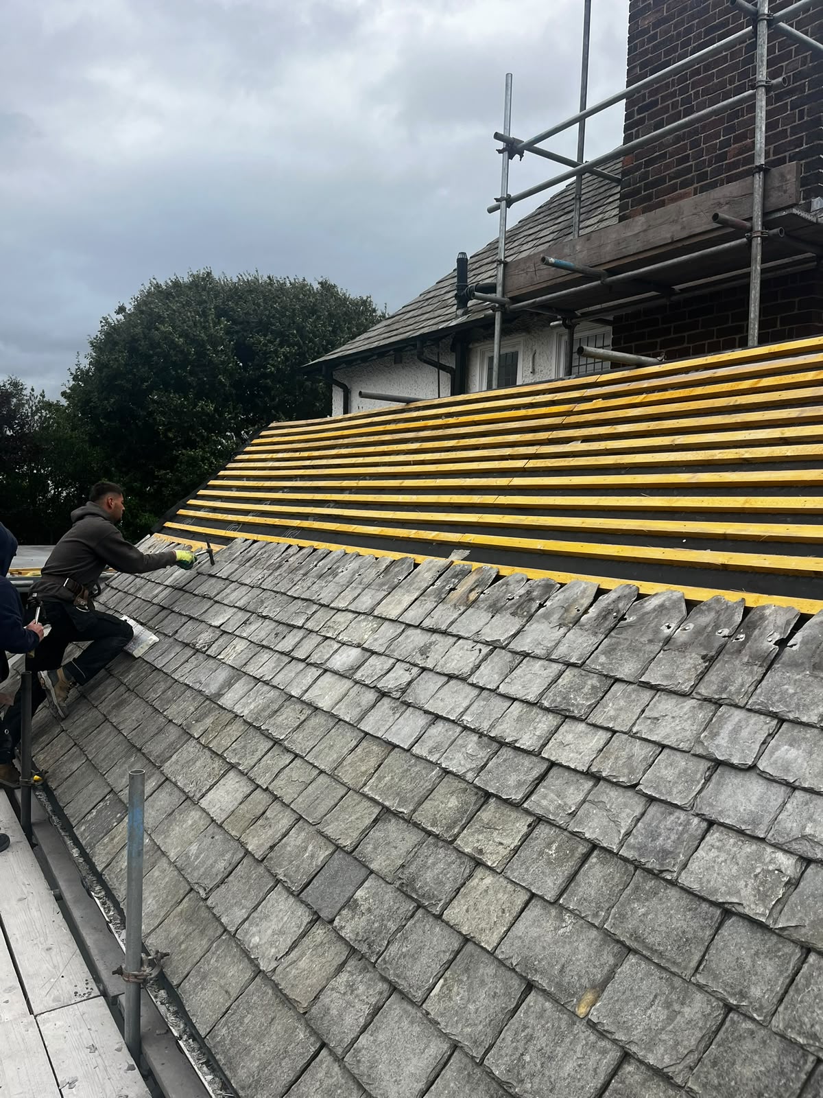 Old slate roof mid-strip with new treated battens installed over breathable underlay by RTC Roofing
