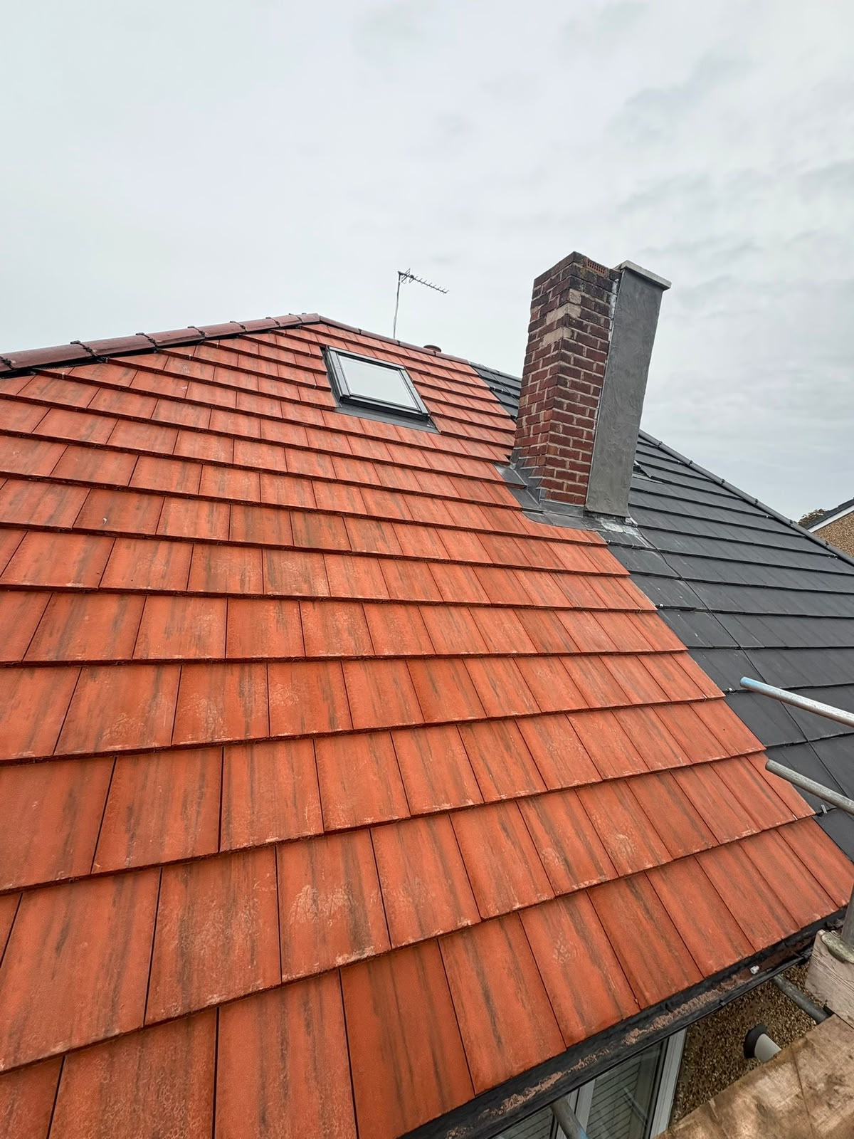 New red clay plain tile pitched roof with Velux skylight and lead flashing by RTC Roofing, Wirral